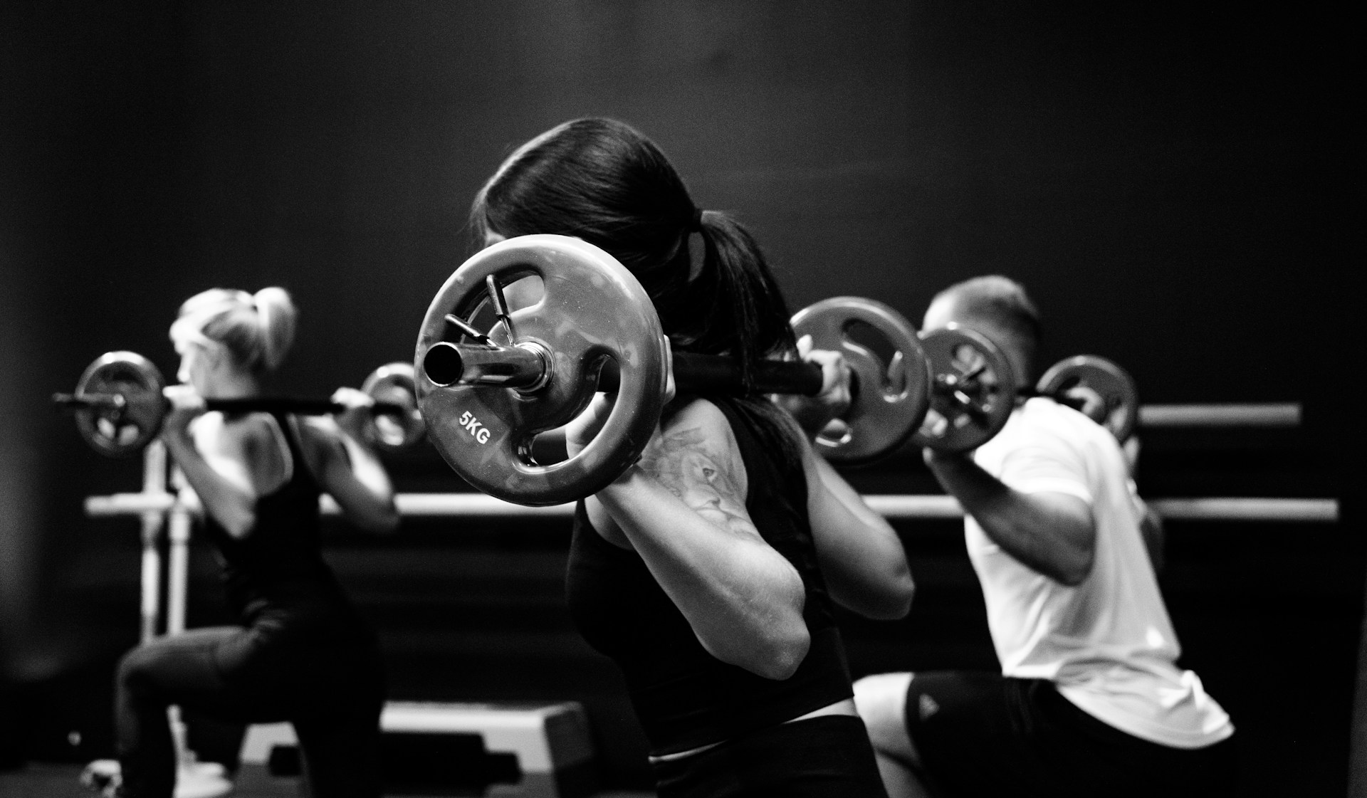 A group fitness class in action, with participants engaged in a high-energy workout